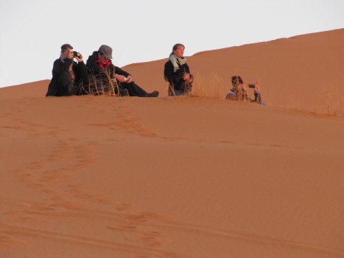 Some of our touring group watching the dawn over the Sahara